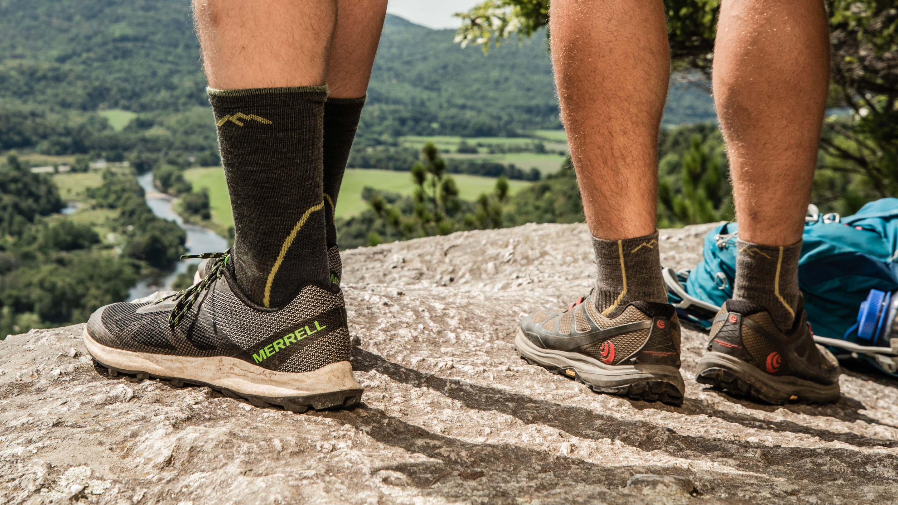 close up on model featuring our Men's Light Hiker Micro Crew and our Men's Light Hiker Quarter socks