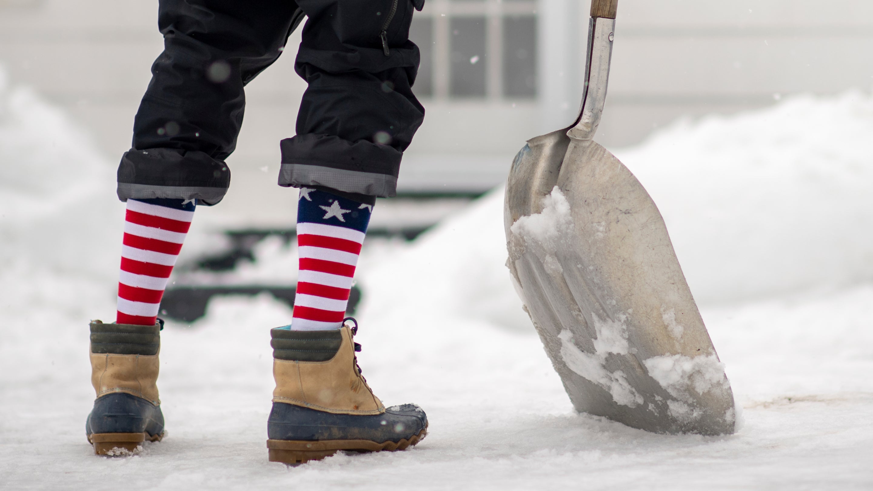close up on model featuring our Men's Captain Stripe Over-The-Calf  Ski and Snowboard sock